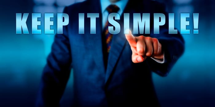 Business coach is pressing KEEP IT SIMPLE! on a virtual touch screen interface. Call to action, motivational appeal and business concept for a straight-forward tactical approach to management.