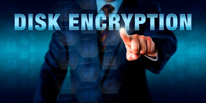 Corporate network administrator is touching DISK ENCRYPTION on a virtual screen. Information technology concept for data conversion into unreadable code to be deciphered by authorized users only.