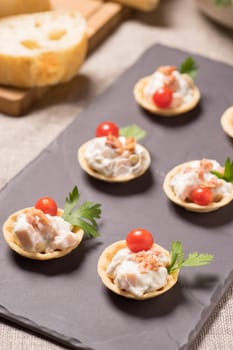 canapes, appetizer with creamy Chicken salad served on a slate plate