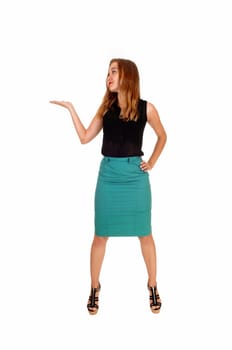 A beautiful slim blond woman standing isolated for white background.looking up and one hand up..