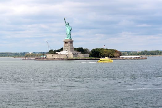The Statue of Liberty (Liberty Enlightening the World), a colossal neoclassical sculpture on Liberty Island in the middle of New York Harbor, Manhattan. The statue is of a robed female figure representing Libertas, the Roman goddess of freedom, who bears a torch and a tabula ansata