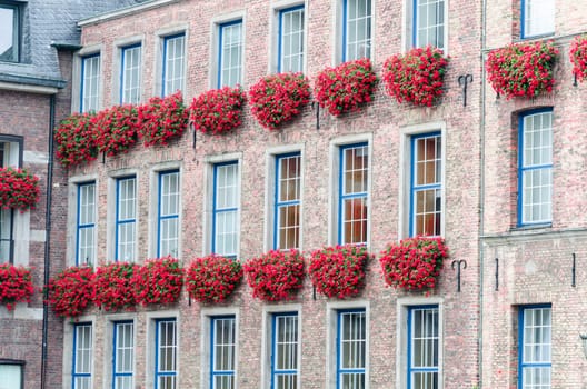 Old historic house facade of the Düsseldorf City Hall with flower boxes at the Jan Wellem monument. Recording in Germany
