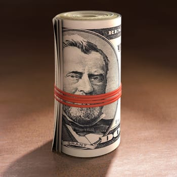 Money roll with elastic gagging the mouth of Ulysses S. Grant.