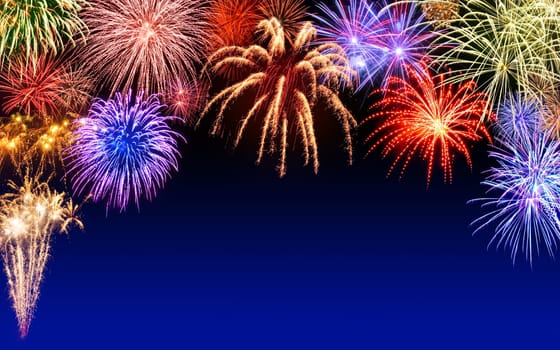 Atmospheric colourful fireworks on a dark blue night sky,with text-free space