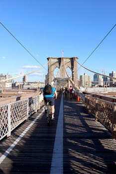 NEW YORK, SEPTEMBER 05: Pedestrians and tourists in Famous historic Brooklyn Bridge in Manhattan over Hudson River in September 05, 2013 in New York.