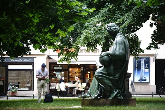 Berlin,Germany - June 21,2016: A tourist photographs the sculpture "Allegory of Science"" by sculptor Albert Wolff at the Nikolaikirche in the Nikolaiviertel on June 21,2016 in Berlin."