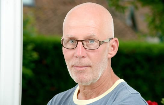 a portrait of a mature man with glasses