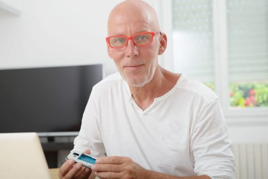 man with glasses repaired a smartphone
