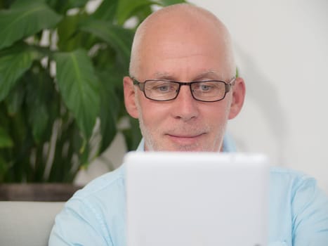a portrait of a mature man with a tablet