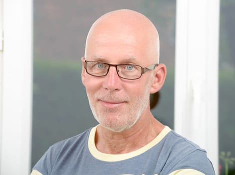 a portrait of a mature man with glasses