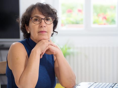 a portrait of a mature woman with glasses