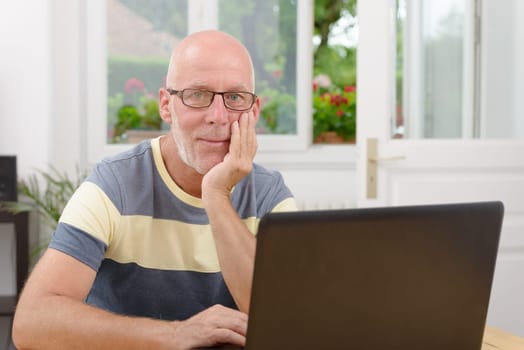 a middle-aged man with a laptop