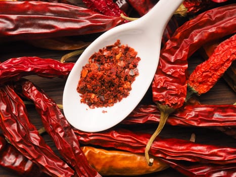 Dried chilies with chili flakes on a spoon