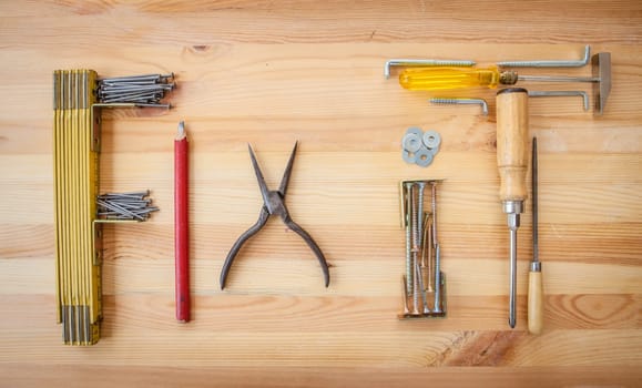Various tools for crafting on a rustic background made of wood