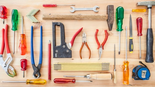 Various tools for crafting on a rustic background made of wood
