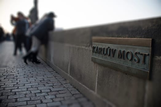 type,board,model,build,travel,city,town,stone,bridge,tourism,attraction,wall,word,prague,metal,style of construction,architecture,architectural style,inscription,destination,letter,medieval,sign,urban,landmark,old,ancient,name,most,spot