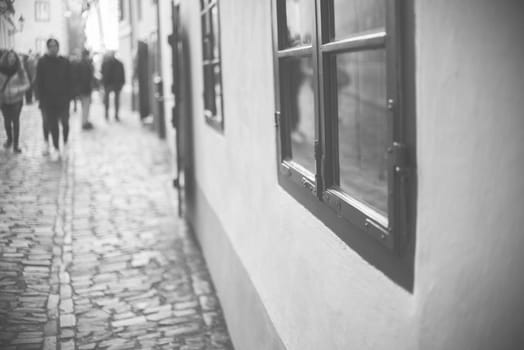 homes along the golden lane in prague castle,full of tourist,focus on window,black and white