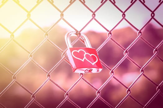 Two hearts on Love Lockers on the fence with pink tone and soft light style