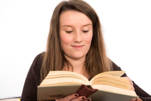young woman in front of white background is reading
