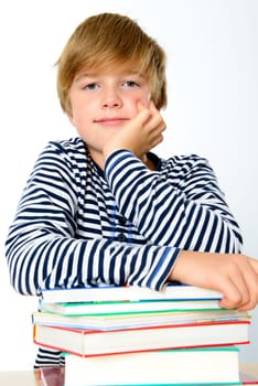 blond boy on a pile of books
