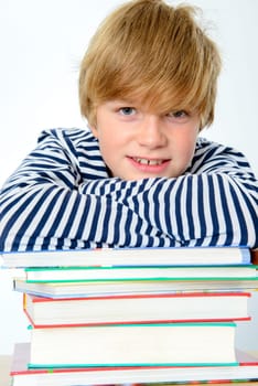 blond boy on a pile of books