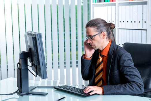 young business man at his desk calling