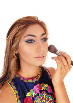 A pretty young woman with brunette hair applying makeup to her.face with a brush, isolated for white background..