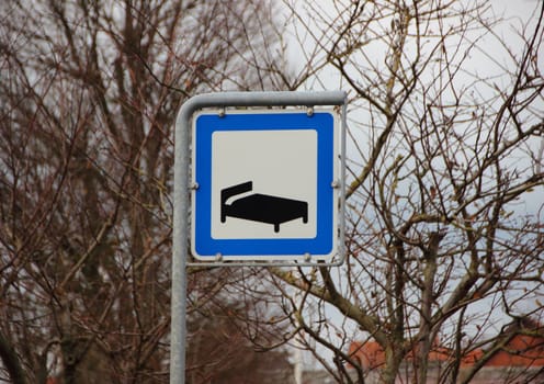 Road Hotel Sleeping Metal Sign Closeup in White and Blue