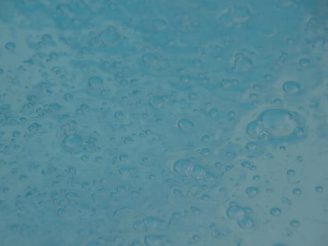 Perspective of Blue Swimming Pool Water Surface with Small Sparkling Bubbles