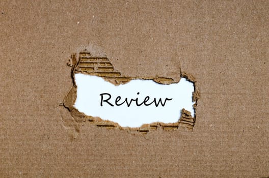 The word review appearing behind torn paper