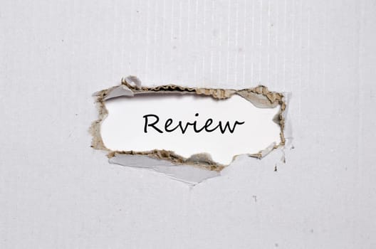 The word review appearing behind torn paper