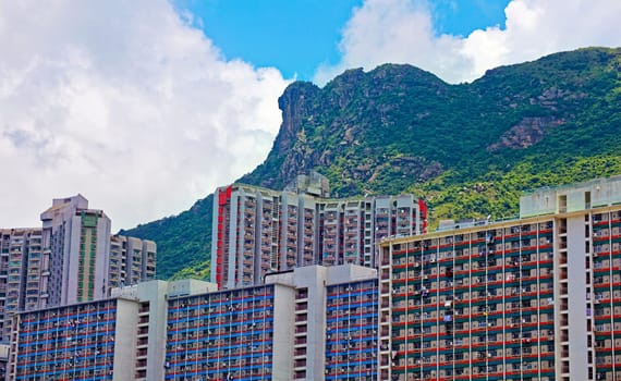 hong kong public estate with landmark lion rock at day