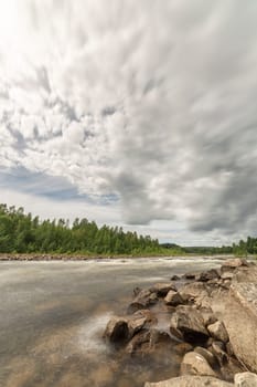 River with Forest and Cloudy Sky.