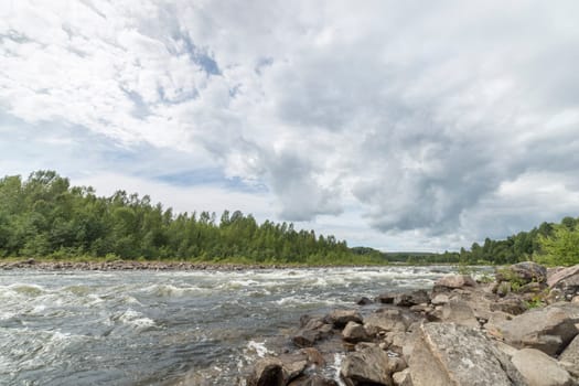 River with Forest and Cloudy Sky.