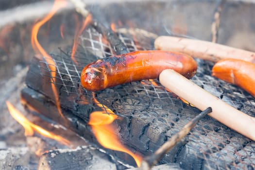 Sausage on Barbecue with Flames.