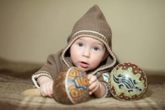 Cute baby playing on the bed, smiling and posing to the camera