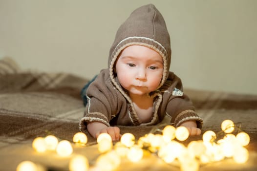 Cute baby playing on the bed, smiling and posing to the camera