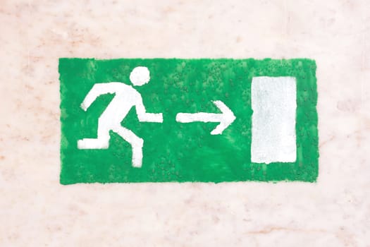 Emergency exit sign, green on a light background, visitor safety, the guests and participants