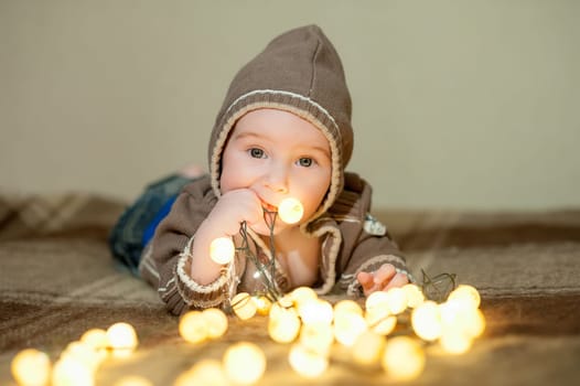 Cute baby playing on the bed, smiling and posing to the camera