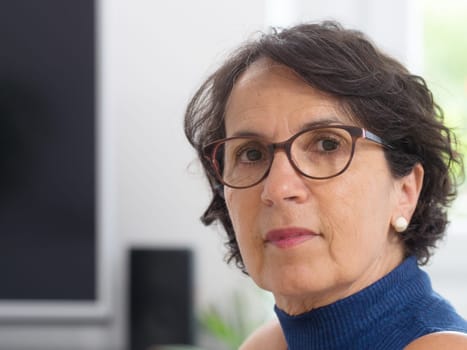 a portrait of a mature woman with glasses