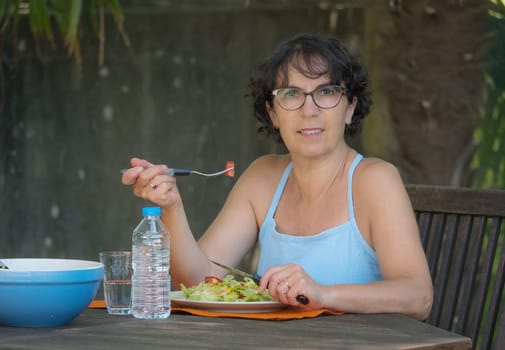 a mature woman lunch in the garden