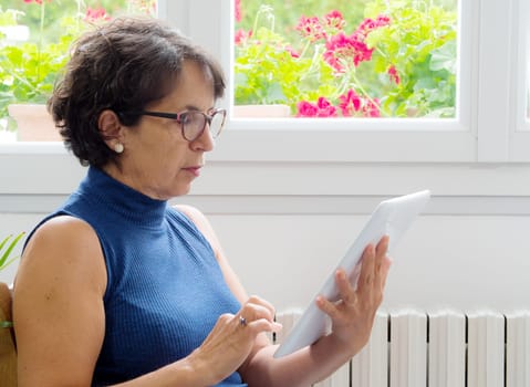 a portrait of a mature woman with a tablet