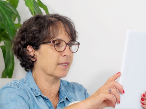 a portrait of a mature woman with a tablet