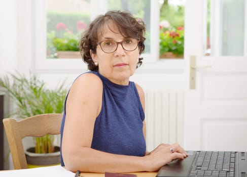 a portrait of a mature woman with glasses