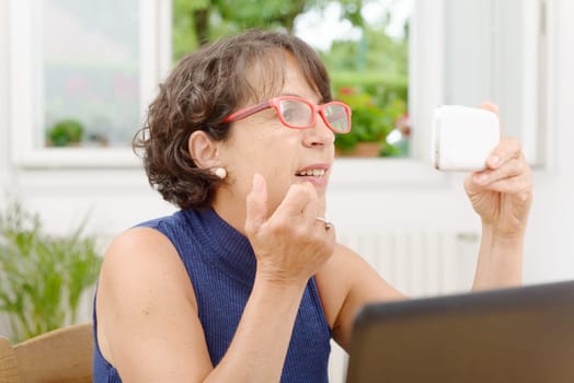 a portrait of a mature woman with a phone