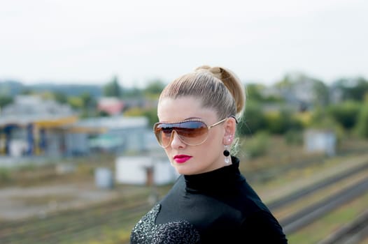 portrait of the beautiful woman against railway tracks, a subject beautiful women and railway roads