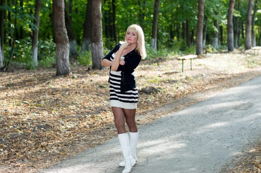 the beautiful woman the blonde costs on a track in park, a subject beautiful women and the nature