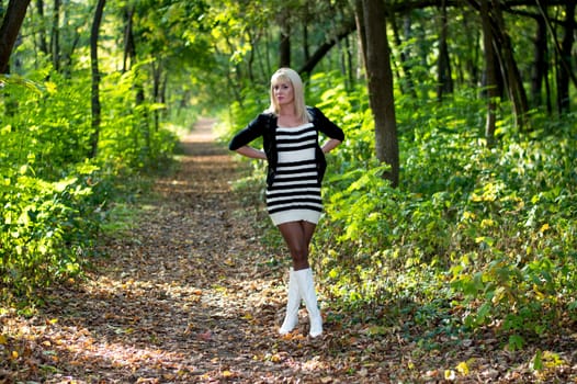the beautiful blonde in white boots on a forest footpath, fall, a subject beautiful women and the nature