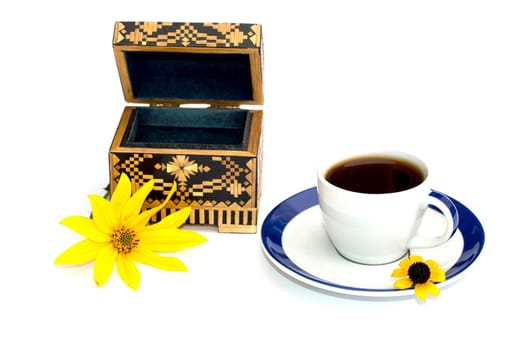 the cup of coffee and casket decorated with a yellow flower, isolate, a subject flowers and drinks, seasons spring and summer