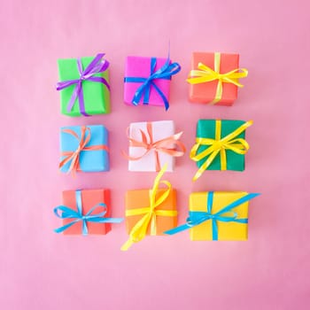 Small gifts wrapped in colorful paper with small ribbons